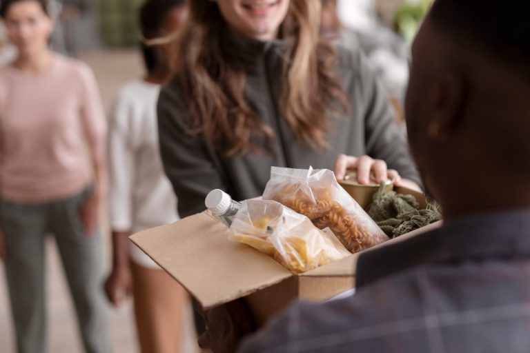 volunteer-handing-donation-box